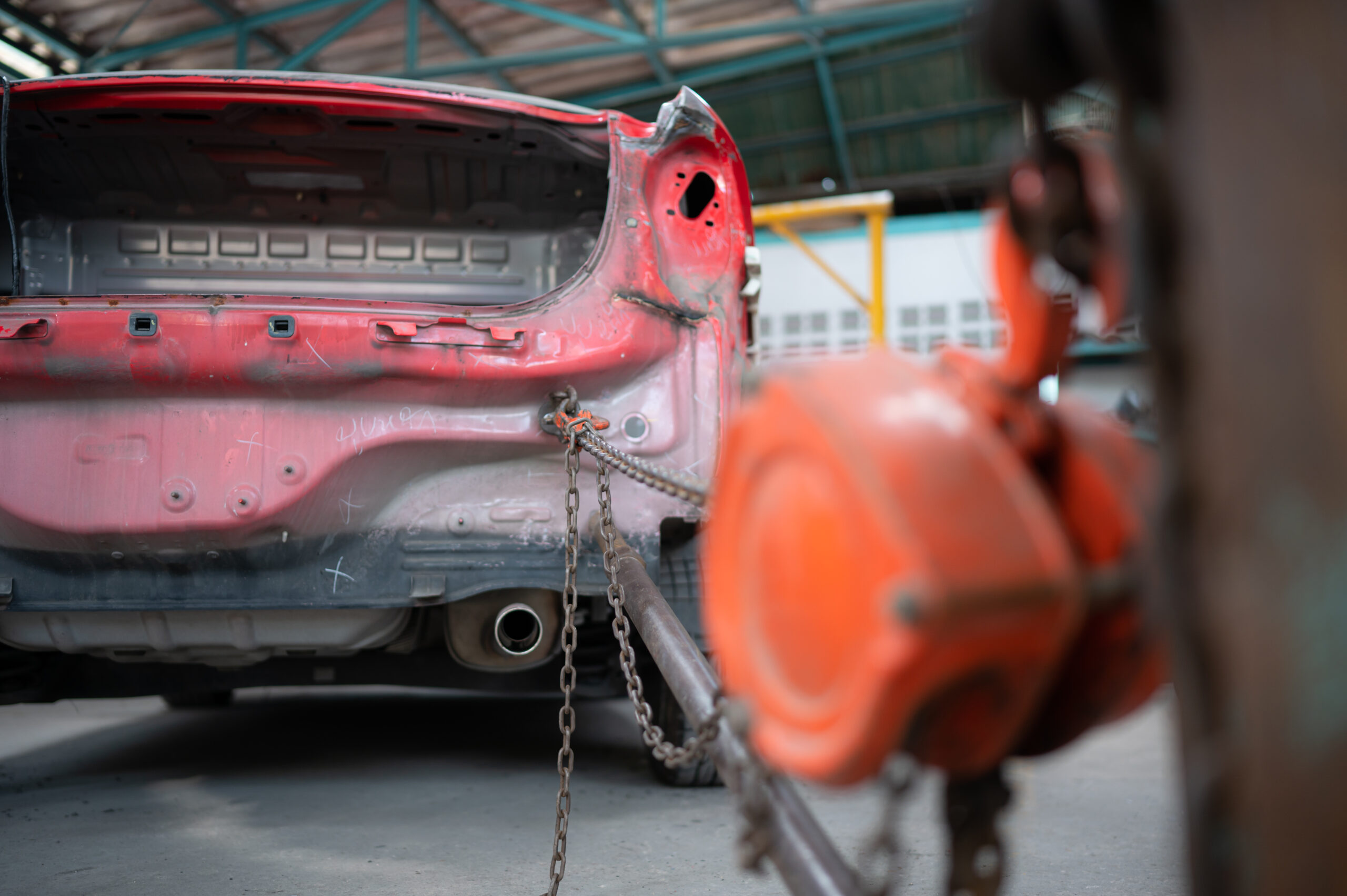 A severely damaged car, its body crumpled and distorted from a high-speed collision.