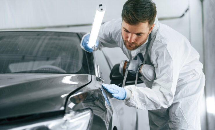 A close-up of the front end of a car, showing the hood, grille, headlights, and bumper.