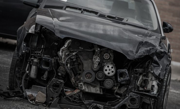 Two cars involved in a head-on collision, with extensive damage to the front ends of both vehicles.