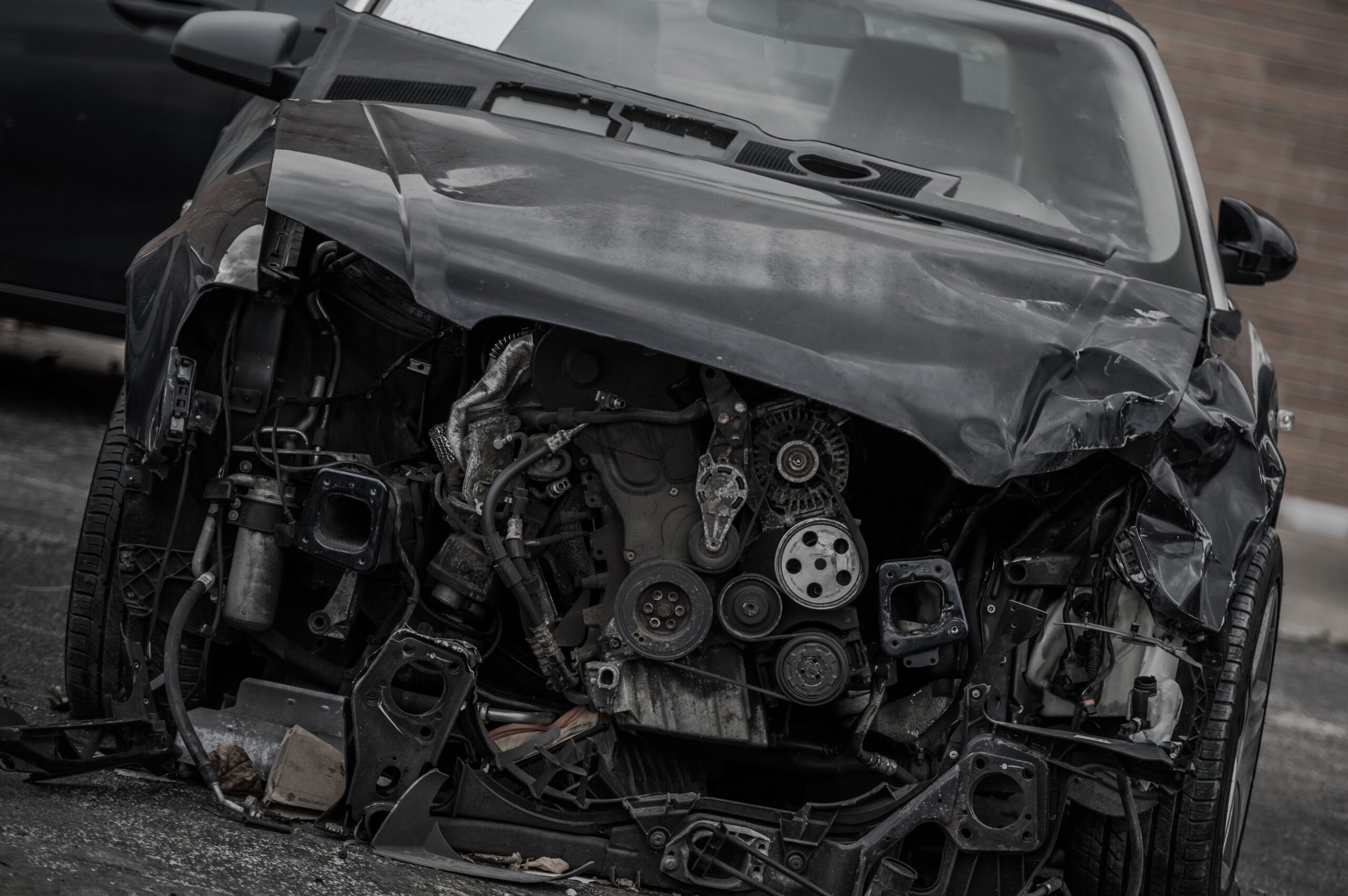 Two cars involved in a head-on collision, with extensive damage to the front ends of both vehicles.